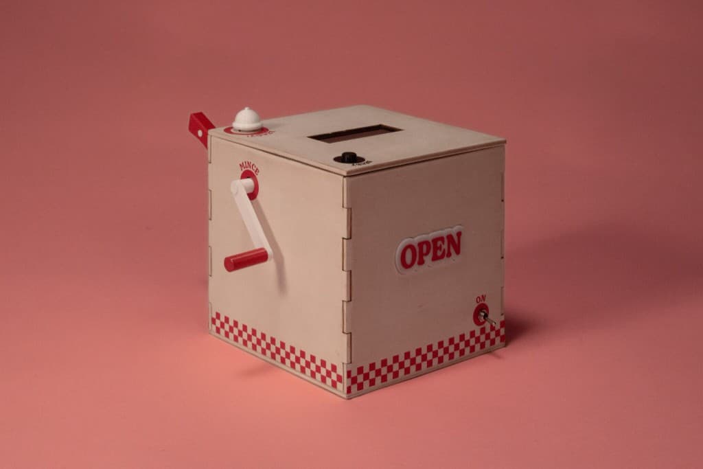 Macchina Franco's e packaging aperto su sfondo rosa